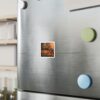 Colorful fridge magnet with landscape photo on stainless steel refrigerator door.