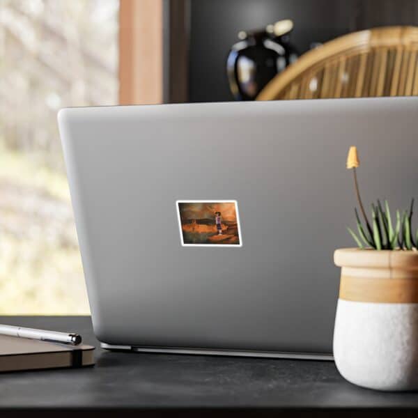 A sleek laptop with a printed photo sticker on the back, placed on a modern workspace with a plant and notebook.