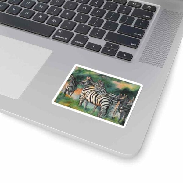 Colorful zebra artwork sticker on laptop touchpad, emphasizing creative computer accessories and design.