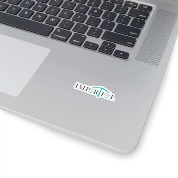 Impartial Inc. sticker on a laptop with a sleek keyboard.