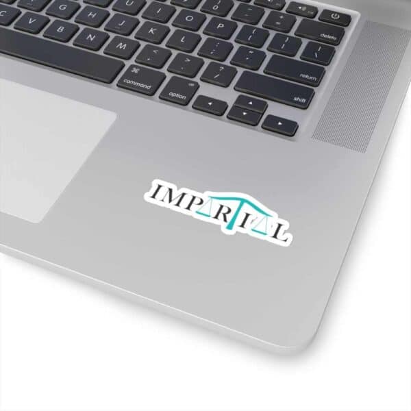 Impartial Inc. sticker on a silver laptop with keyboard, promoting unbiased legal services.