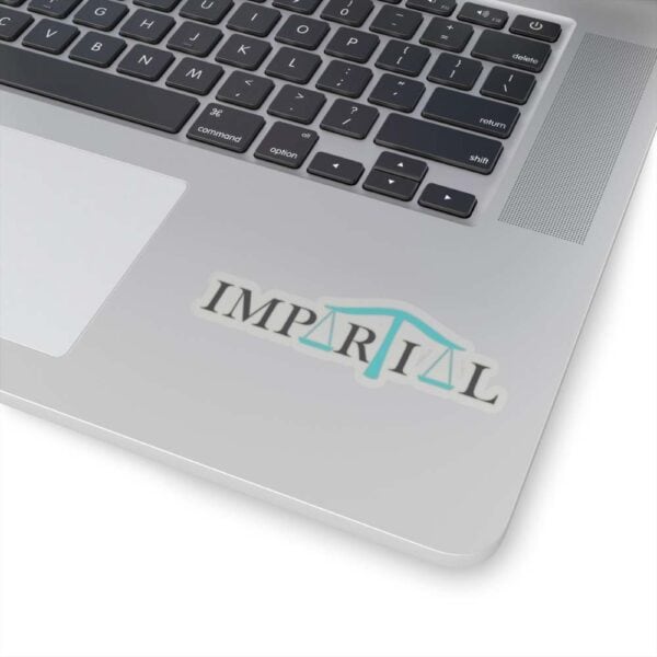 Scales integrated into the Impartial logo on a MacBook keyboard, symbolizing fairness and balanced judgment.