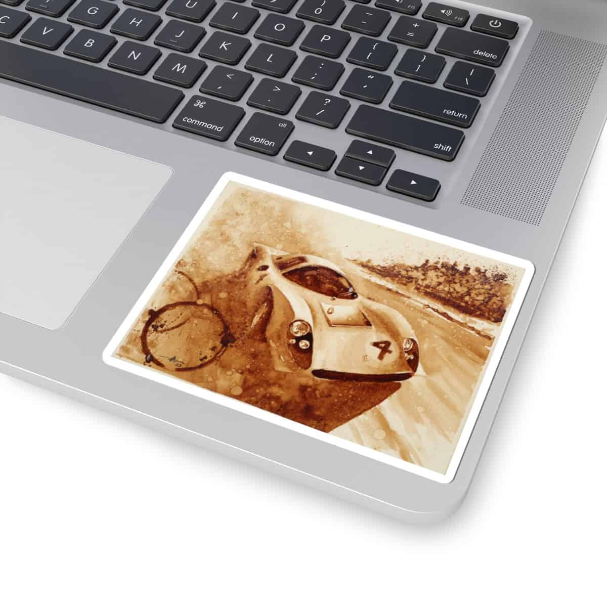 Vintage race car artwork on a laptop touchpad with a racing clock.